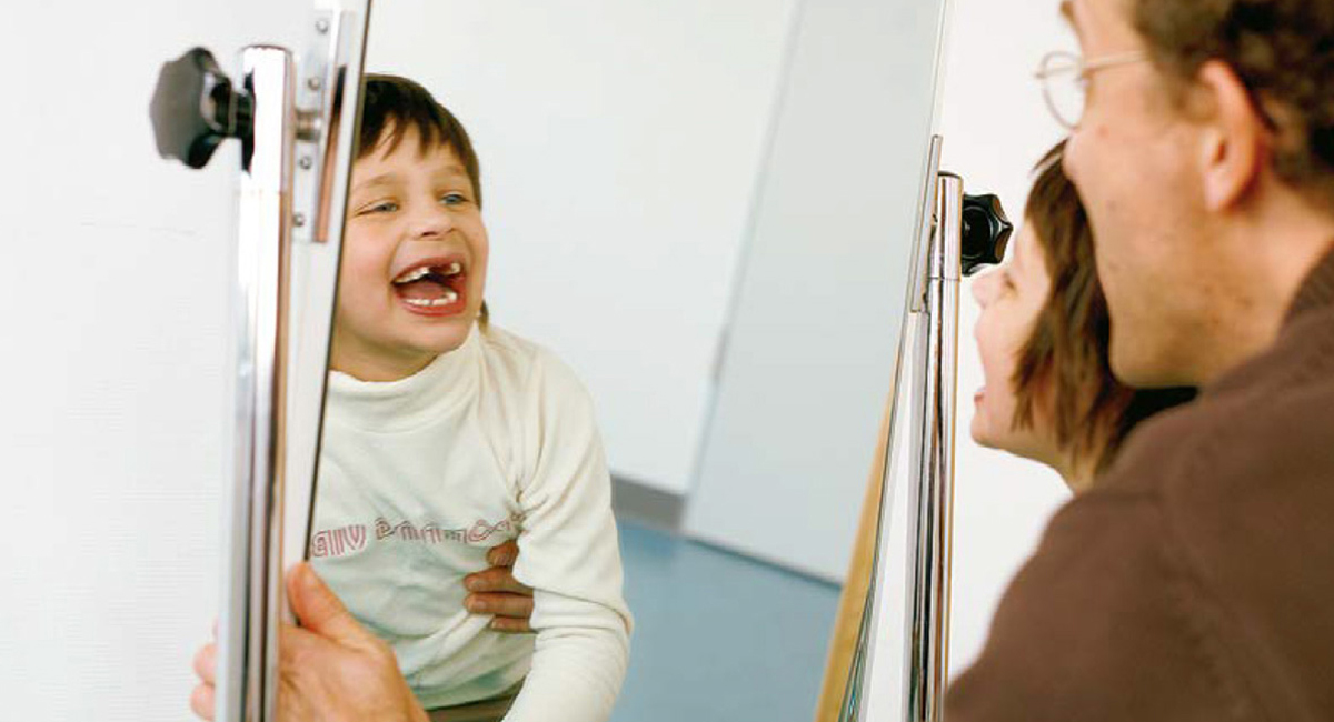 Ein Junge mit Autismus in der Therapie mit einem Therapeuten